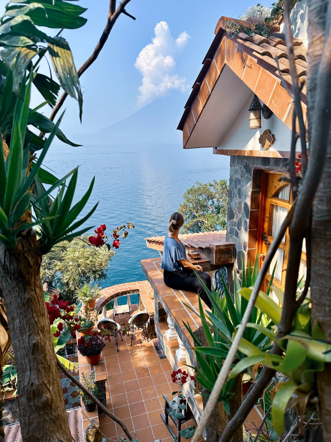 Sitting on the balcony at Casa Del Mundo overlooking the volcanos surrounding Lake Atitlan in Guatemala