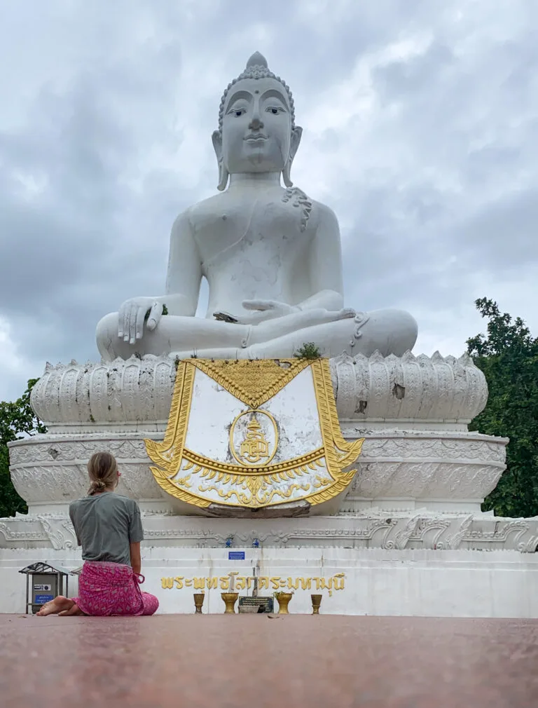 Visiting The White Buddha in Pai, Thailand, refers to a large, white Buddha statue located at the Wat Phra That Mae Yen temple
