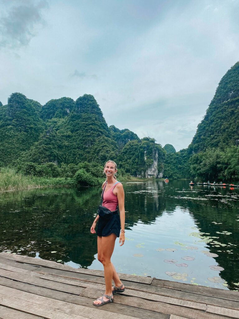 Trang An Boat tour in Ninh Binh Vietnam. Wearing the perfect dryable tank top and shorts which are necessary for a Vietnam packing list.