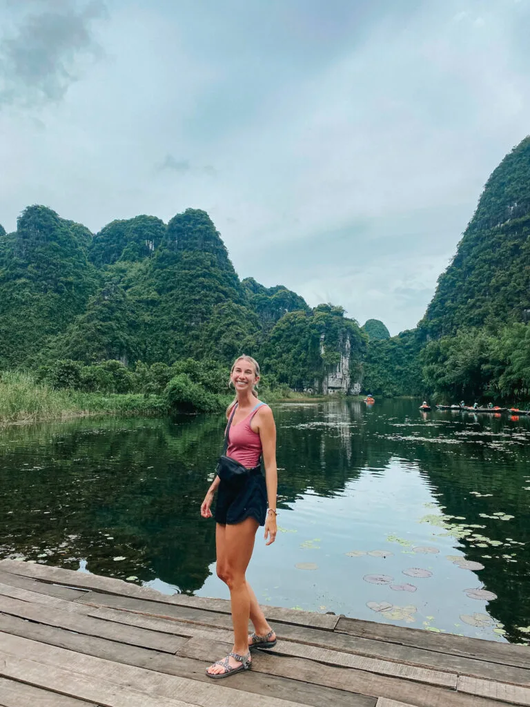 Trang An Boat tour in Ninh Binh Vietnam. Wearing the perfect dryable tank top and shorts which are necessary for a Vietnam packing list.