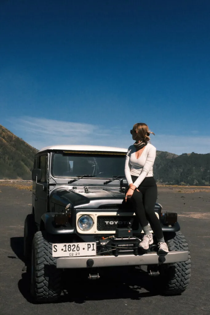 Sitting on an antique 4x4 in front of Mt. Bromo in Indonesia