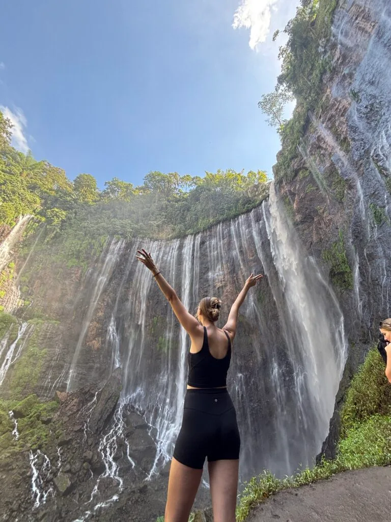 Tumpak Sewu Waterfall cascading down a lush green cliff in East Java