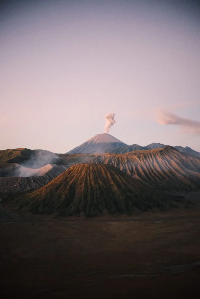 Pinkish glow of the sunrise hitting Mt Bromo after a sunrise hike in Indonesia on the East Java Tour

